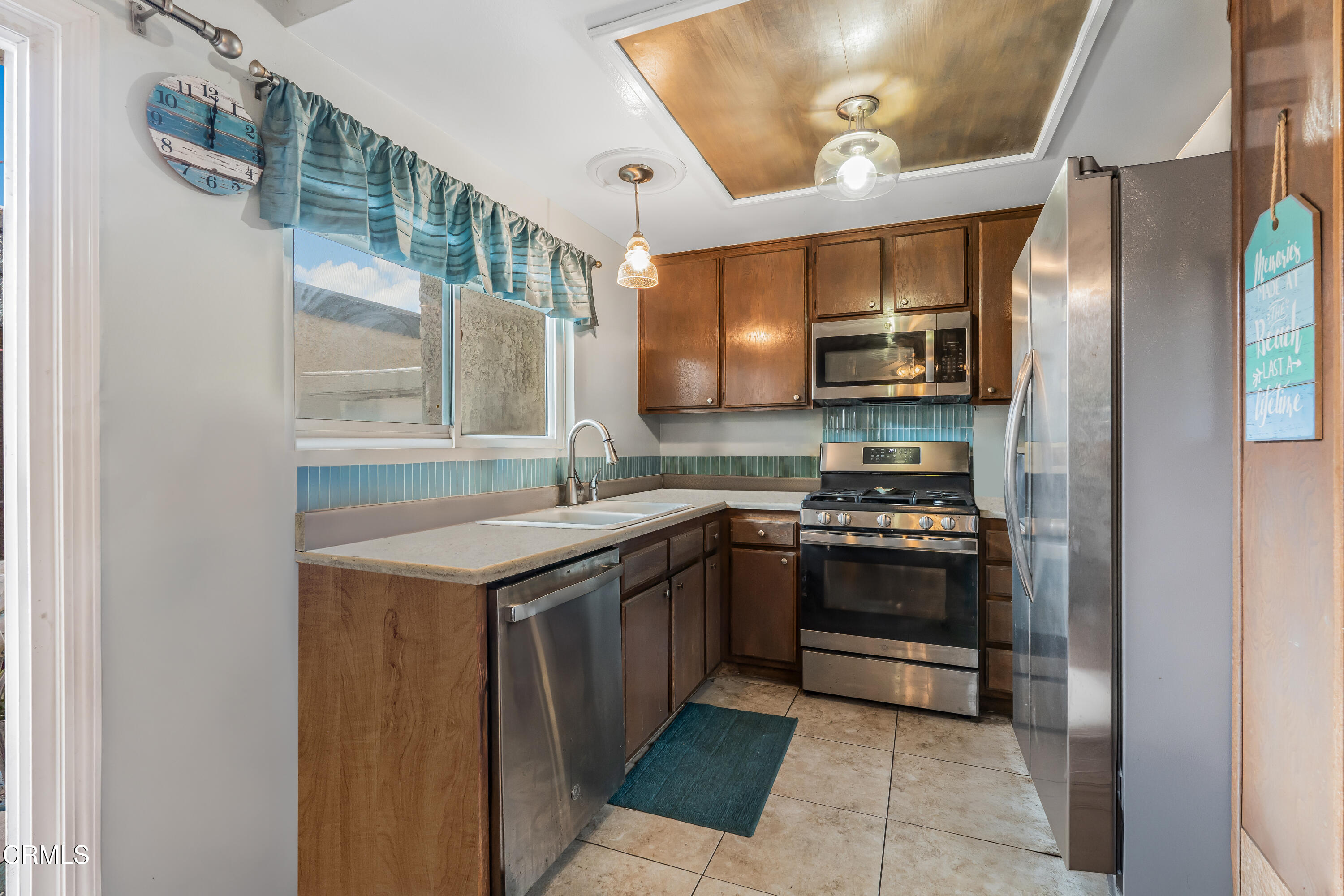 5289 Perkins Road Oxnard, CA 93033 - Photo 6 of 23 a kitchen with stainless steel appliances granite countertop a stove and a sink