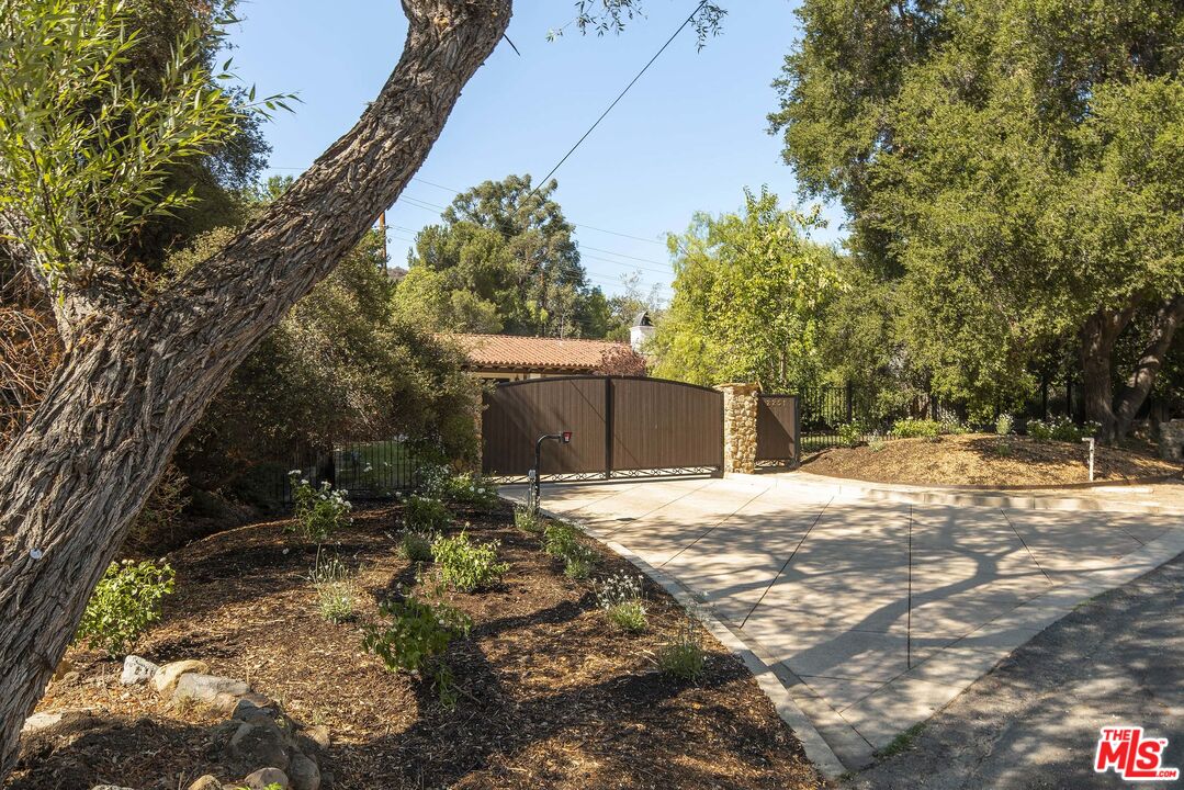 2251 Cold Canyon Road Calabasas, CA 91302 - Photo 36 of 47 a backyard of a house with large trees and outdoor space
