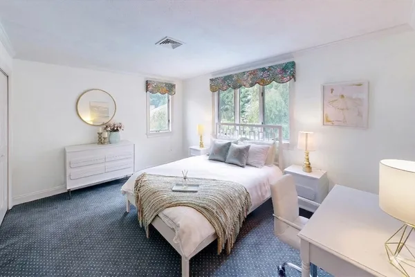 a bedroom with a bed and a chair