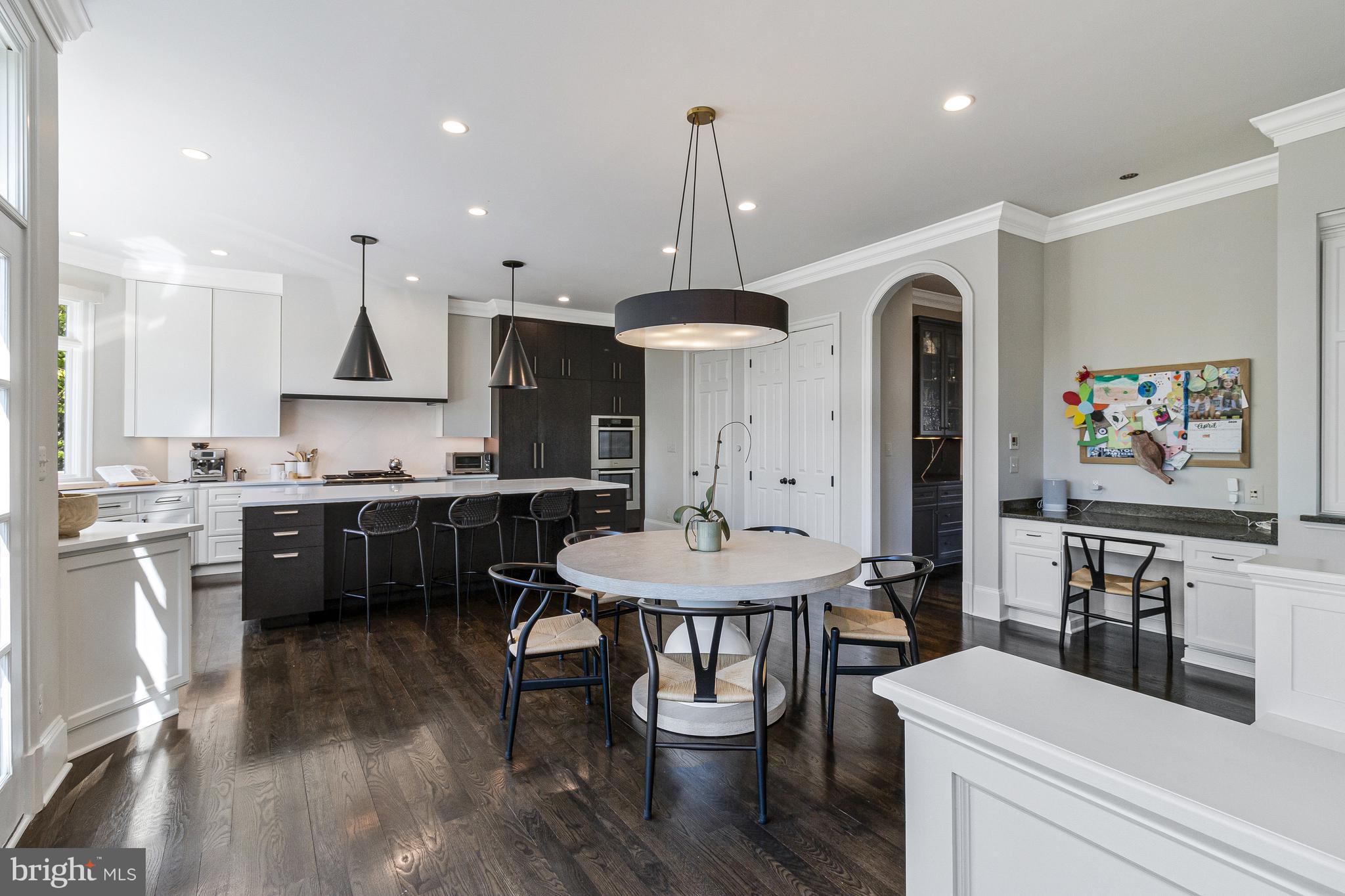 4502 32nd Road North Arlington, VA 22207 - Photo 37 of 57 a kitchen with stainless steel appliances kitchen island granite countertop a sink a stove a refrigerator and a dining table with wooden floor