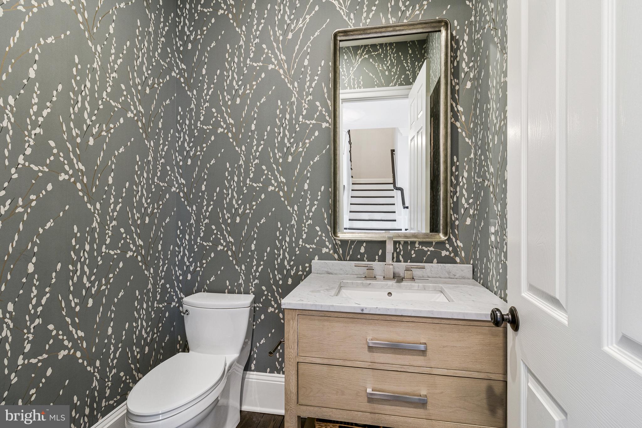 4502 32nd Road North Arlington, VA 22207 - Photo 41 of 57 a bathroom with a granite countertop sink toilet and mirror