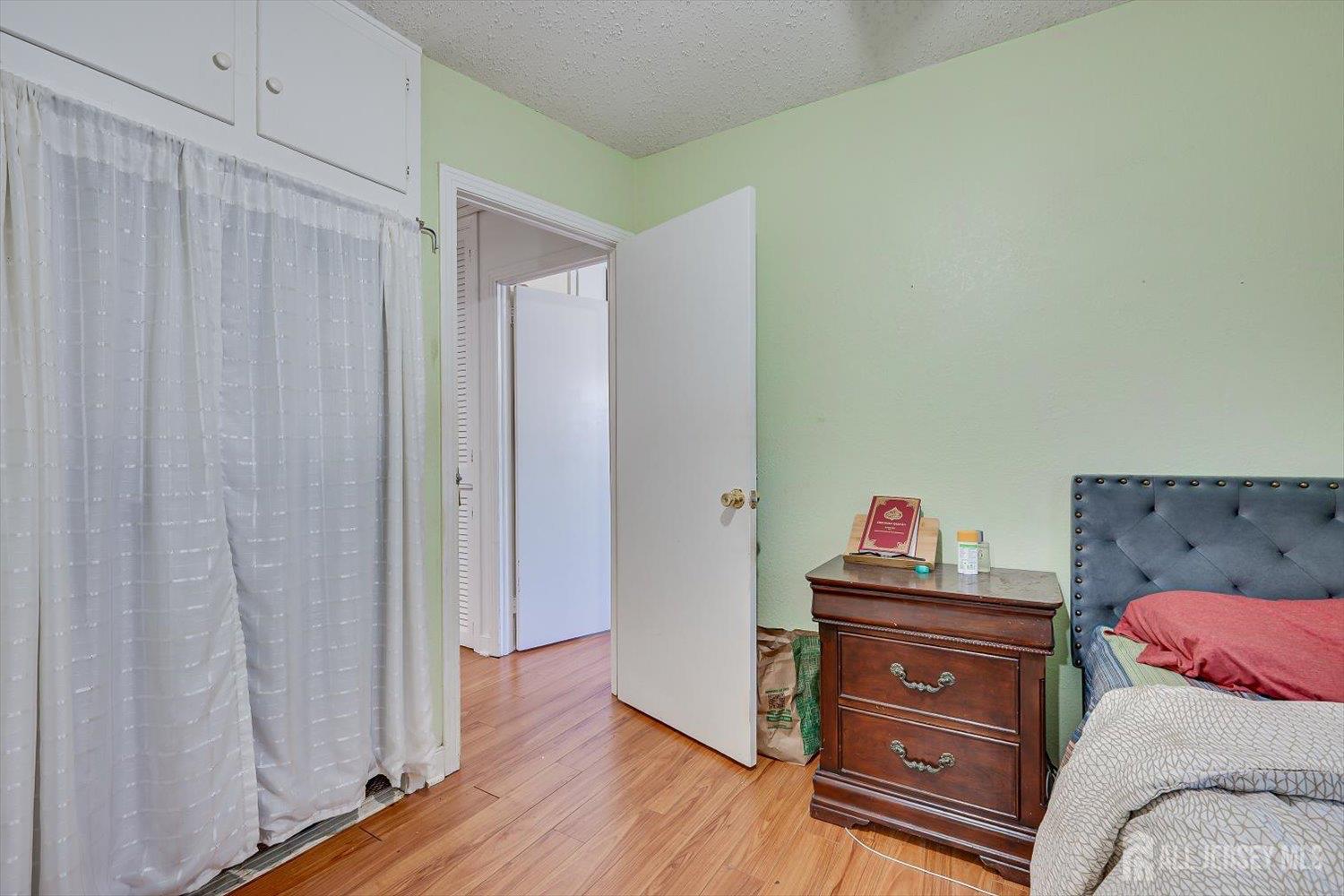 15 Markham Road Edison, NJ 08817 - Photo 28 of 32 a bedroom with a bed and wooden floor