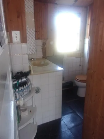 a bathroom with a granite countertop toilet and a sink