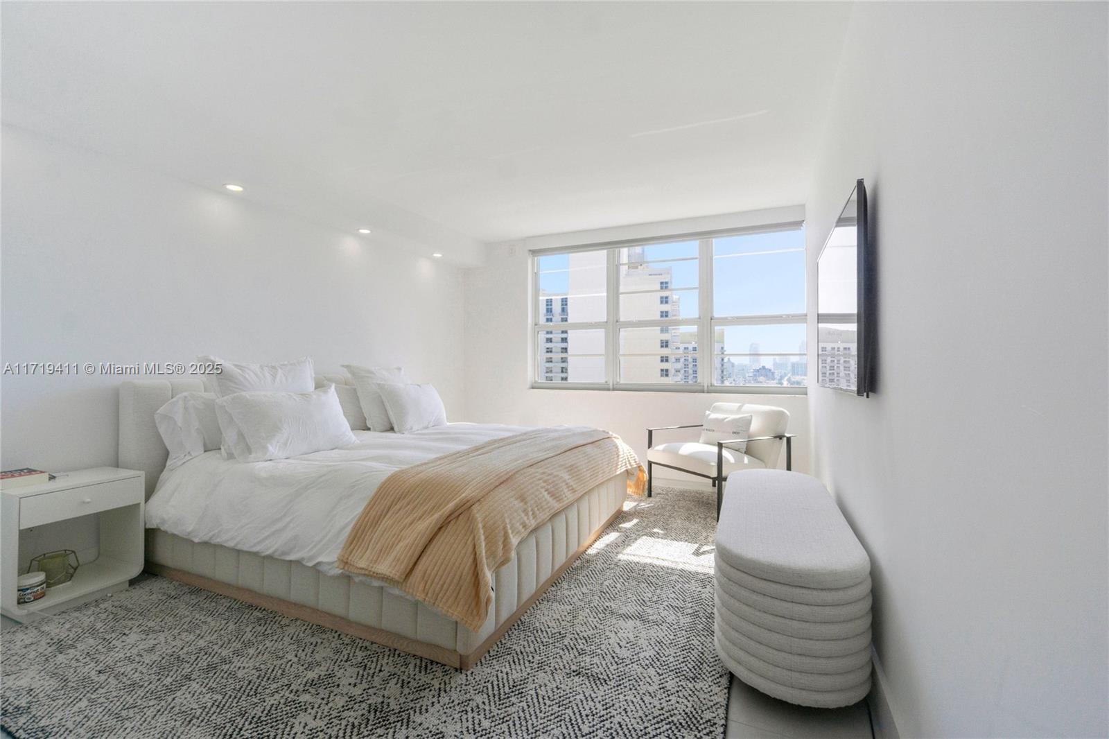 100 Lincoln Road, Unit 1411 Miami Beach, FL 33139 - Photo 14 of 36 a bedroom with a bed and a chair