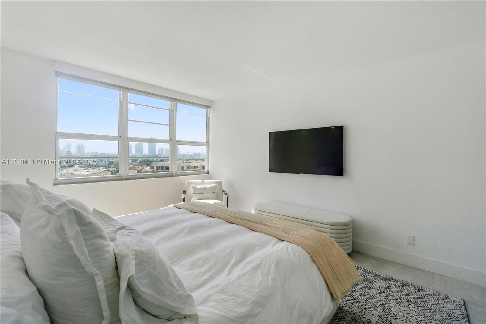 100 Lincoln Road, Unit 1411 Miami Beach, FL 33139 - Photo 15 of 36 a spacious bedroom with a bed and a flat screen tv