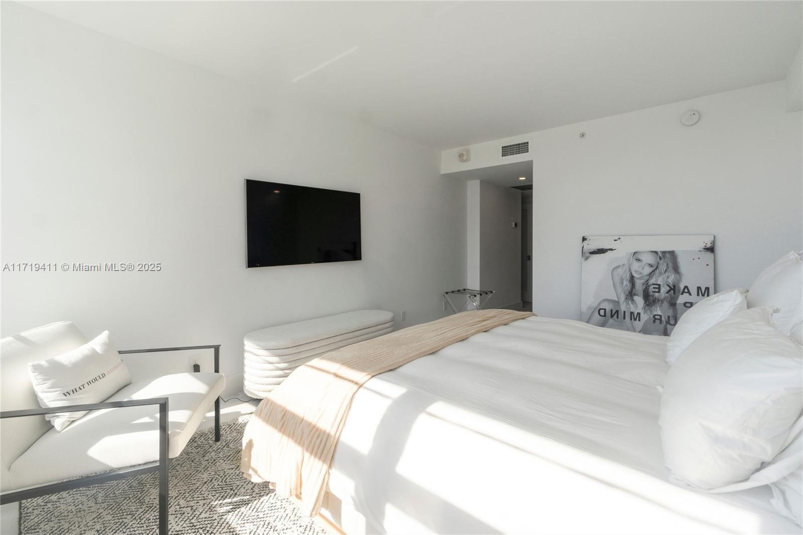 100 Lincoln Road, Unit 1411 Miami Beach, FL 33139 - Photo 17 of 36 a bedroom with a bed and a flat screen tv