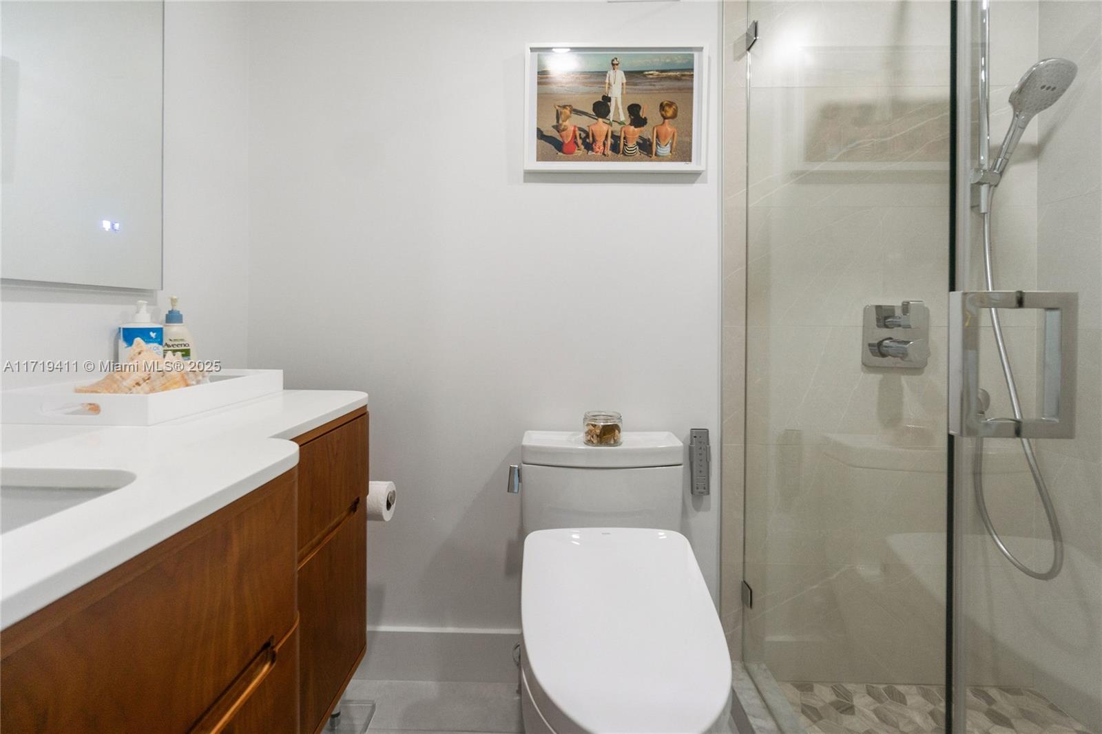 100 Lincoln Road, Unit 1411 Miami Beach, FL 33139 - Photo 10 of 36 a bathroom with a toilet sink vanity and shower