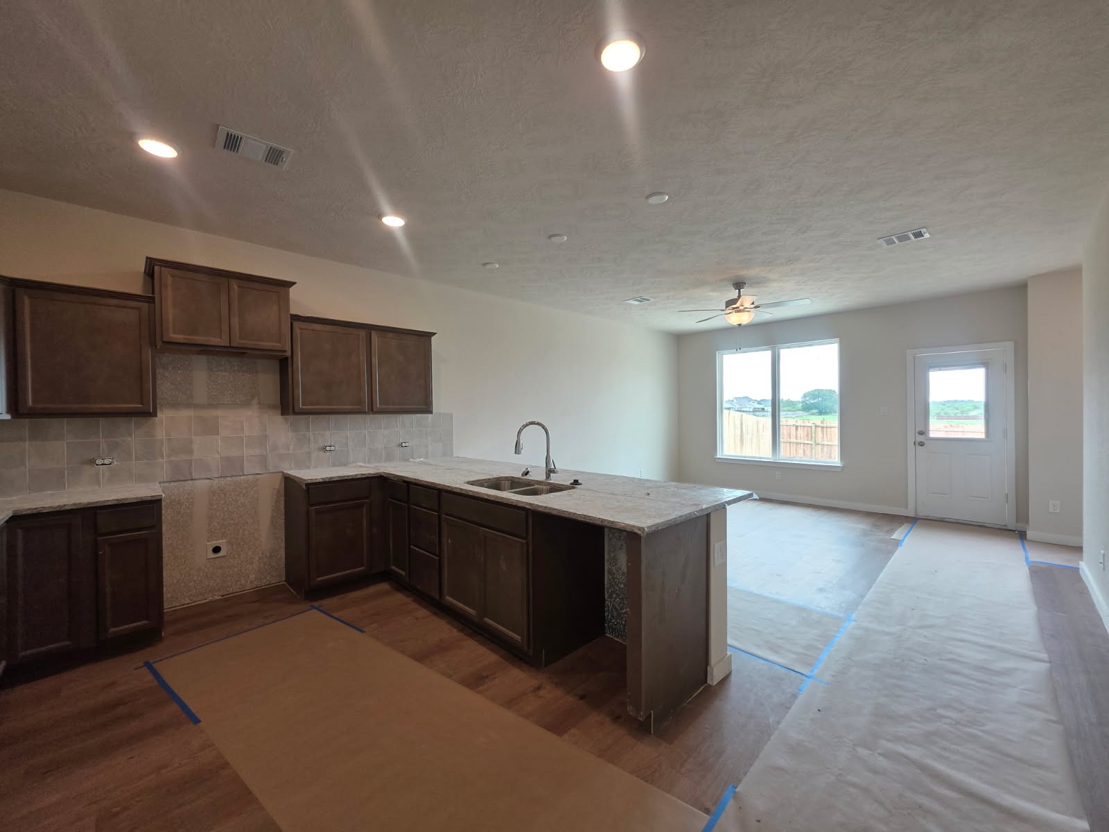 1498 Lk Rdg Drive Brenham, TX 77833 - Photo 3 of 14 a large kitchen with stainless steel appliances granite countertop a sink and dishwasher a stove top oven with wooden floor