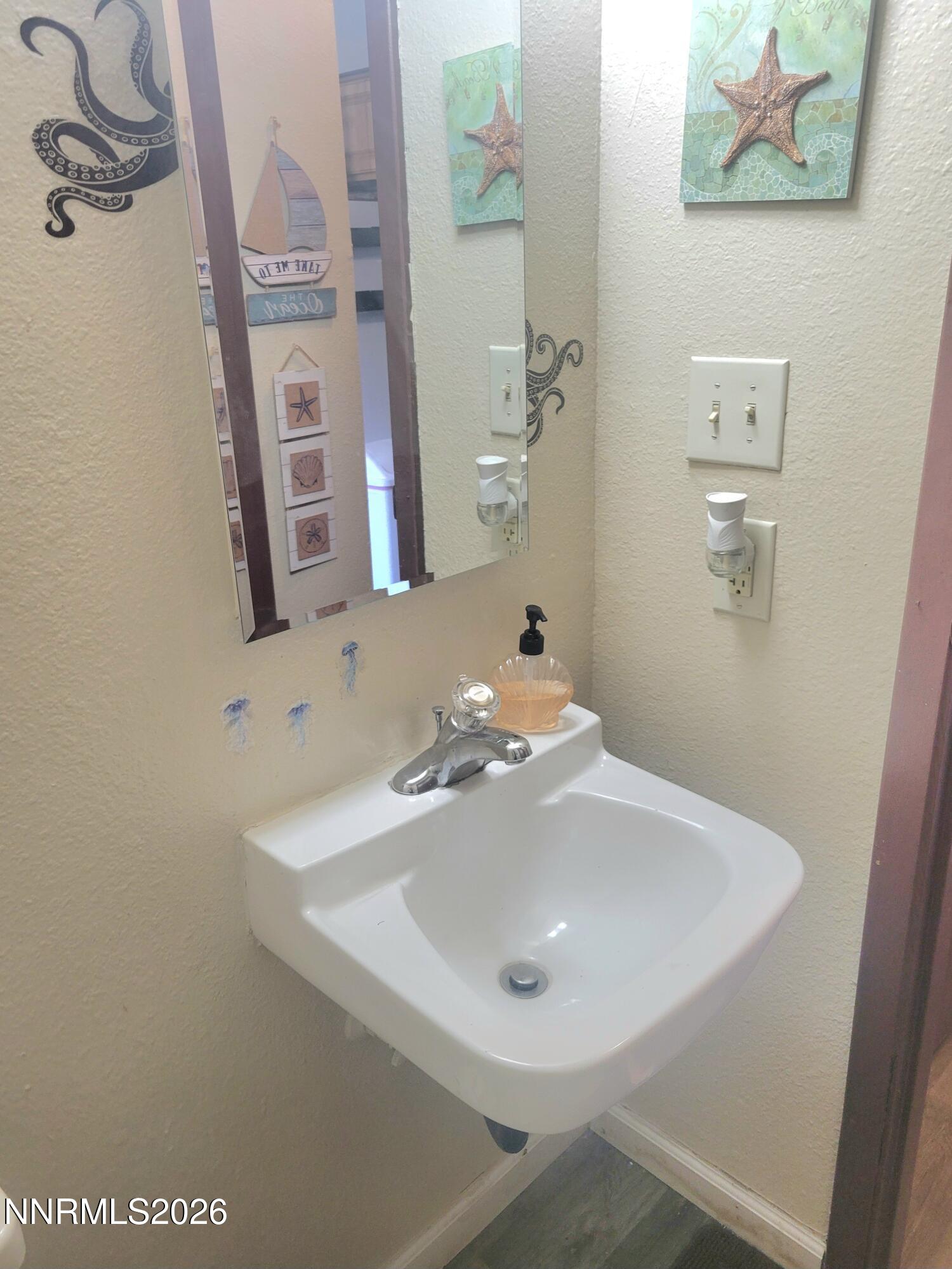 1404 East 9th Street, Unit 3 Reno, NV 89512 - Photo 15 of 29 a bathroom with a sink and a mirror