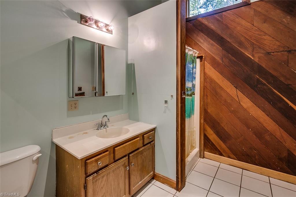 6886 Coltrane Mill Road Randleman, NC 27317 - Photo 14 of 30 Hall bath, ceramic tile floor