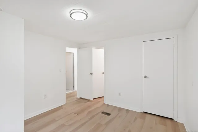 a view of room with wooden floor