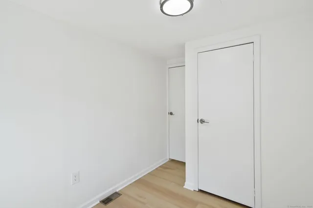 a view of a room with wooden floor