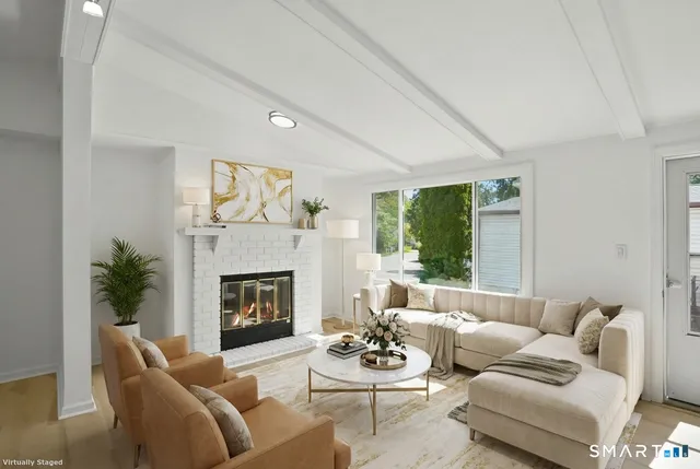 a living room with furniture couches and a fireplace