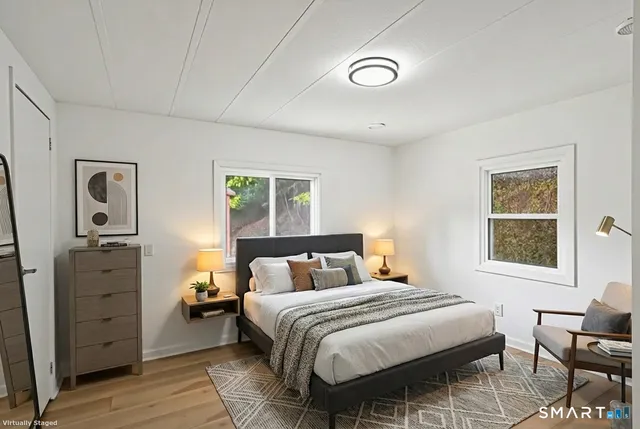 a bedroom with a bed and wooden floor