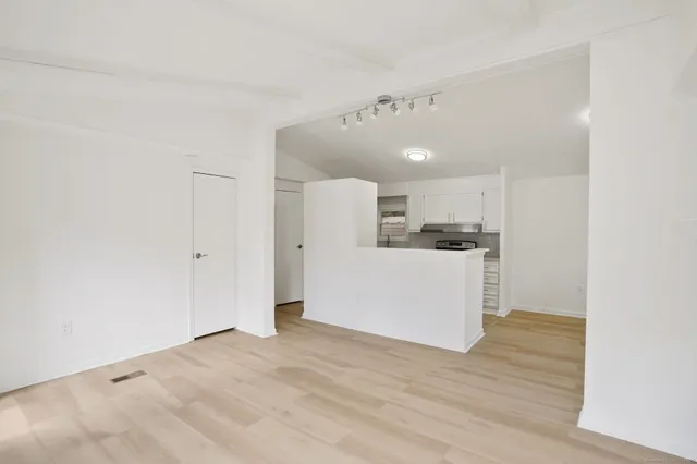 a view of a kitchen with wooden floor