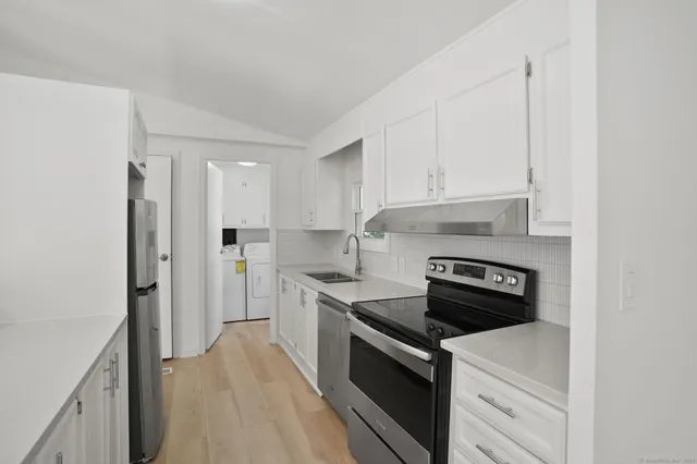 a kitchen with a stove and a refrigerator