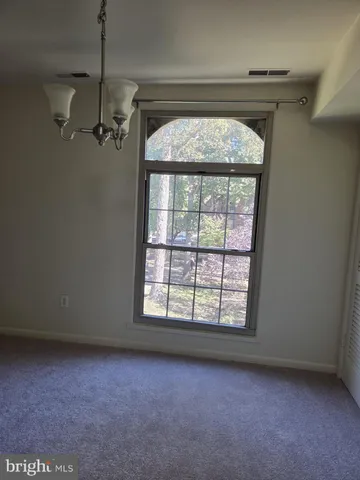 an empty room with a empty space and windows
