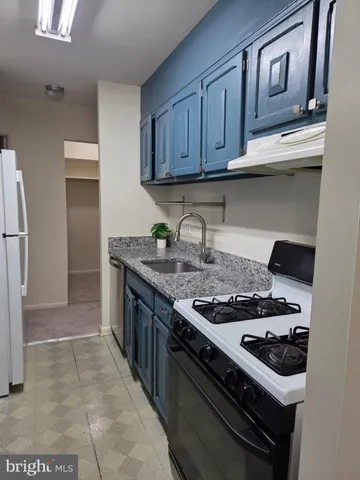 a kitchen with stainless steel appliances granite countertop a stove and a refrigerator