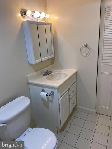 a bathroom with a sink toilet and mirror