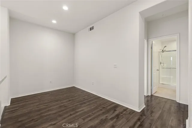 a view of room with wooden floor