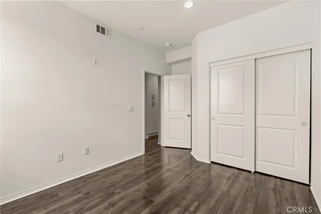 a view of an empty room and wooden floor