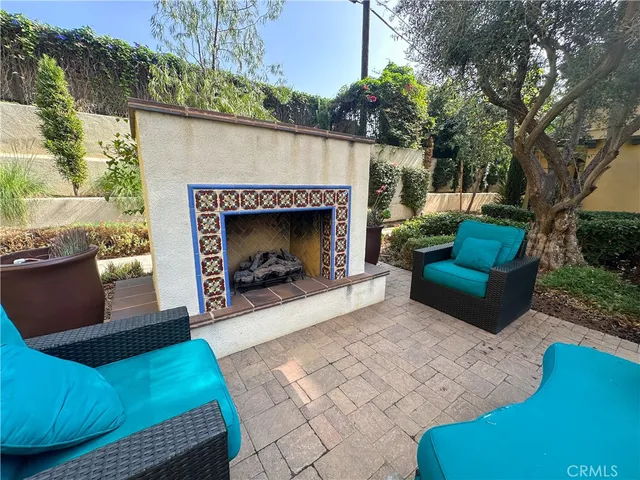 a building outdoor space with patio furniture and a fireplace