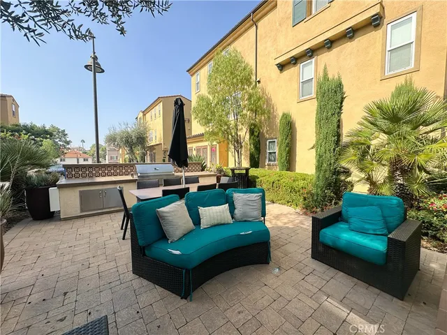a view of a patio with couches and a fire pit and a table