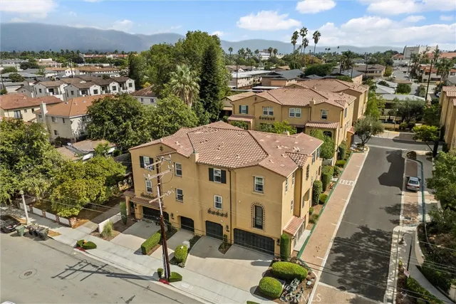 an aerial view of a residential apartment building with a yard