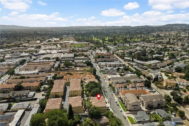 an aerial view of residential houses with city view