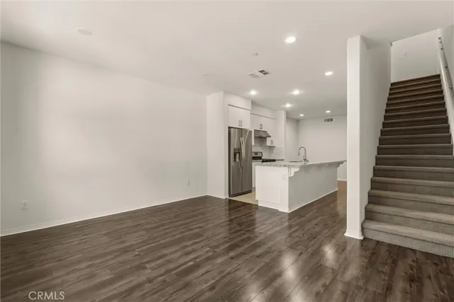a view of kitchen with refrigerator and microwave