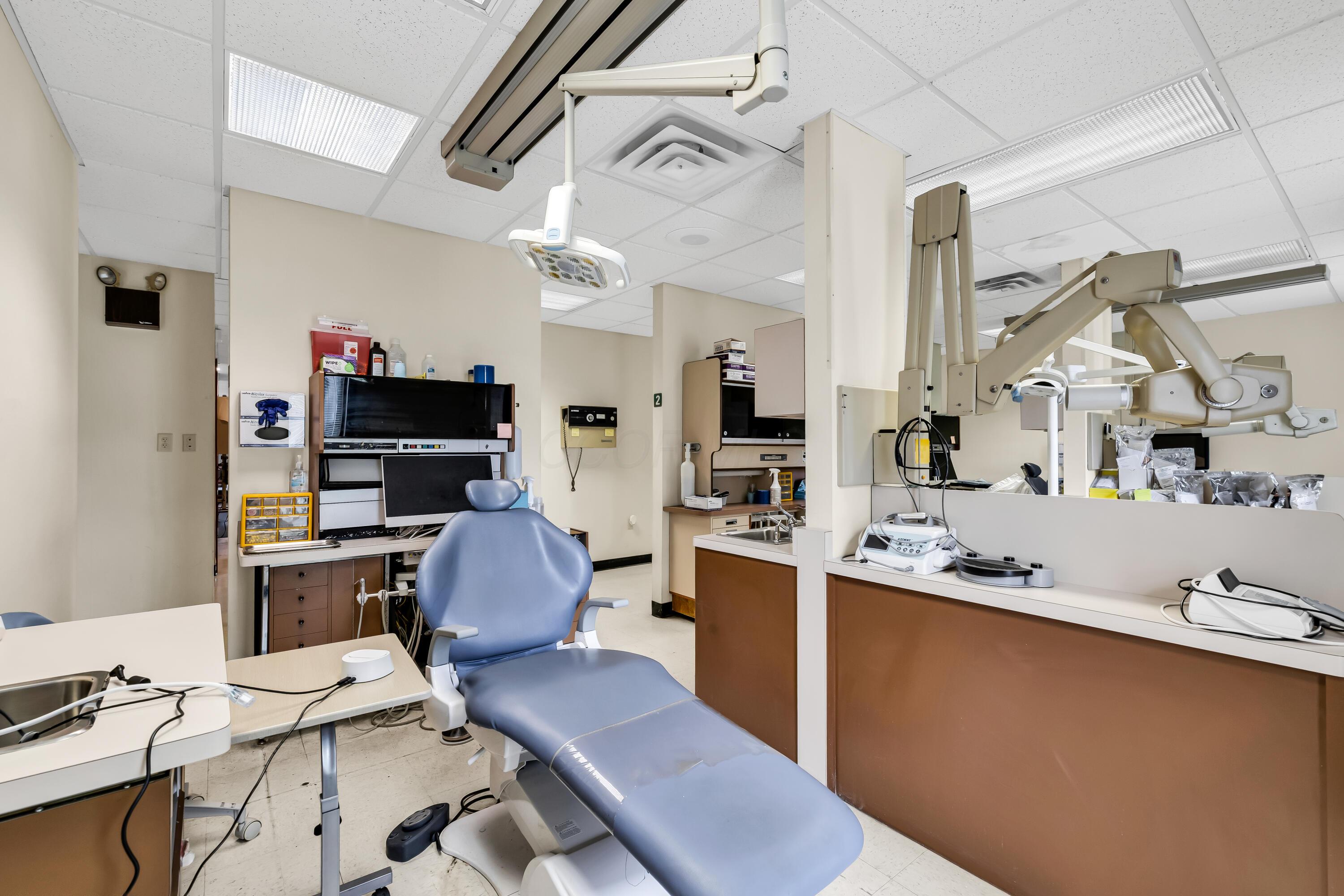 1240 Crescent Heights Road Marion, OH 43302 - Photo 42 of 60 • Neutral vinyl flooring • Ivory painted walls • Acoustic ceiling tiles • Fluorescent lighting • Enclosed vanity with single bowl, stainless steel sinktop • Divider • Lighting & equipment do not remain • Plumbed for oxygen & nitrogen
