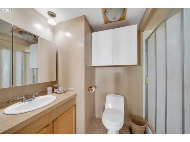 a bathroom with a sink a toilet and a mirror