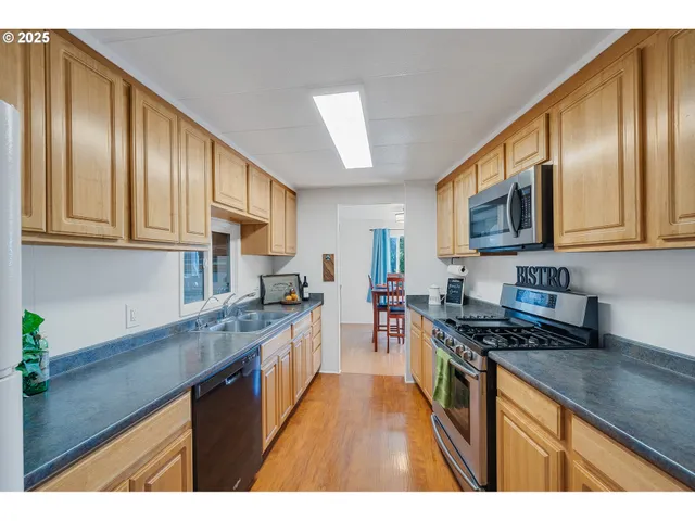 a kitchen that has a sink and a stove top oven