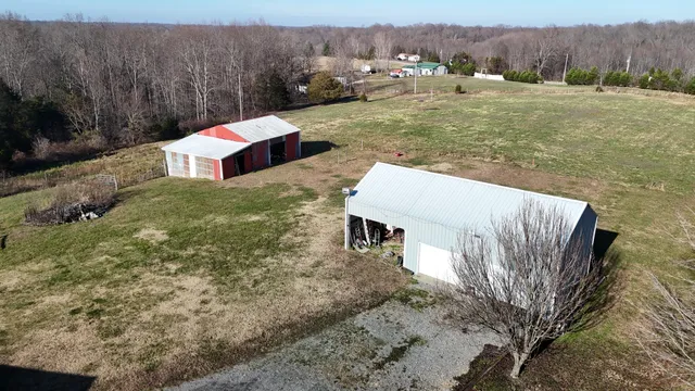 a view of a house with backyard and road