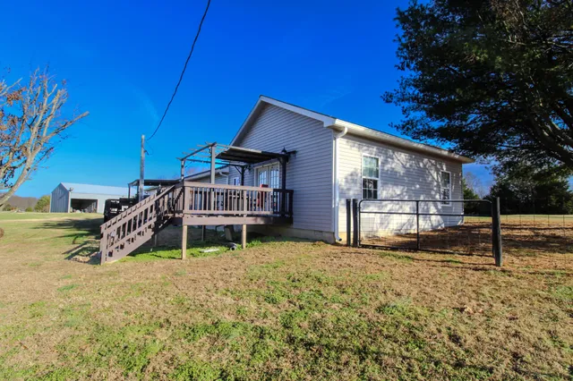 a living room with stainless steel appliances furniture a kitchen view and a kitchen counter top