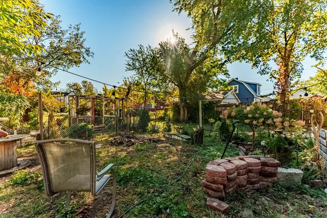 a view of a patio with table and chairs with wooden fence and plants