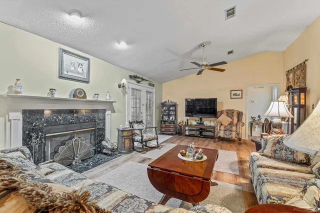 a living room with furniture and a fireplace