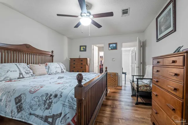 a large bedroom with a bed and furniture