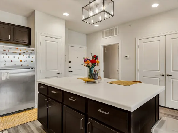 a kitchen with kitchen island a sink appliances and cabinets