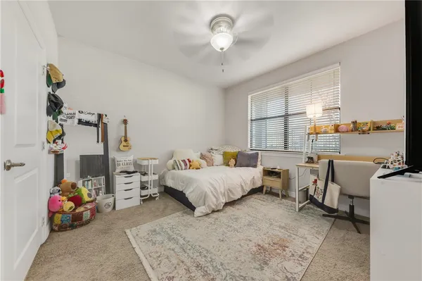 a bed room with a bed window and a chandelier