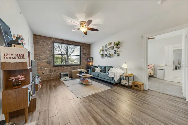 a living room with furniture and a wooden floor
