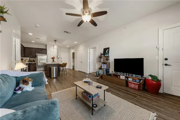 a living room with furniture and a flat screen tv