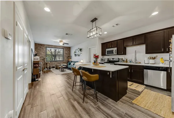 a kitchen with a sink appliances and cabinets