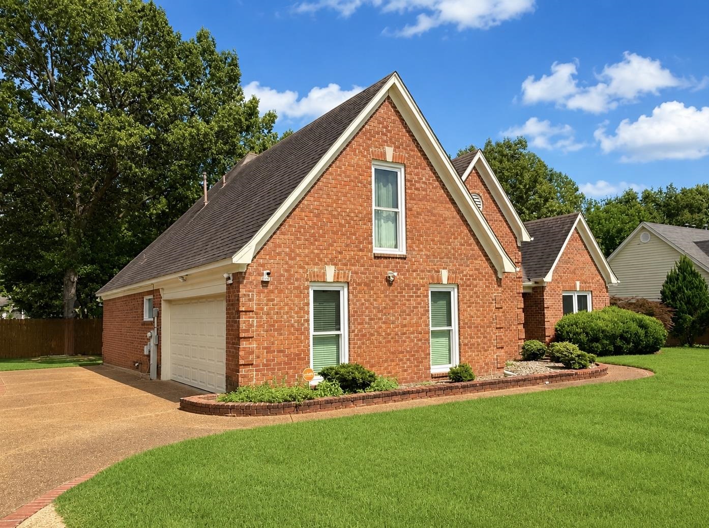 326 South Sanga Road Cordova, TN 38018 - Photo 4 of 32 Brick exterior featuring multiple gables, white window casings, and a dark shingle roof