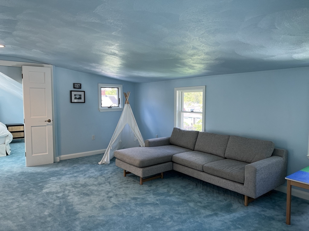 11 Garrison Road, Unit 1 Arlington, MA 02474 - Photo 39 of 42 a living room with furniture and a window