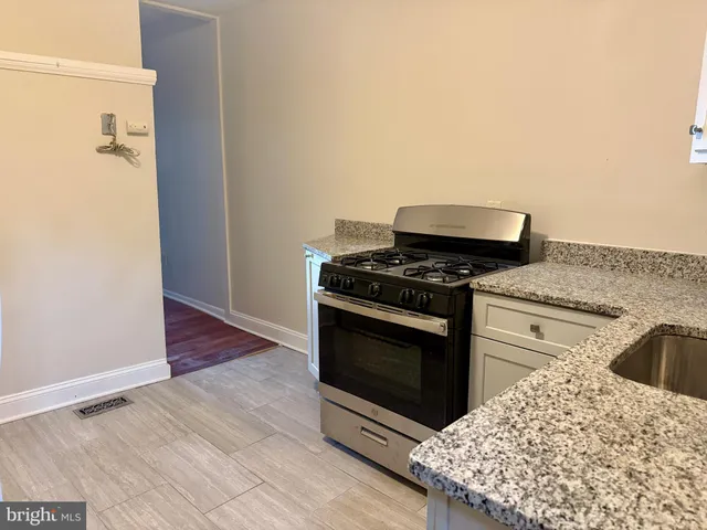 a kitchen with a stove and a white cabinet