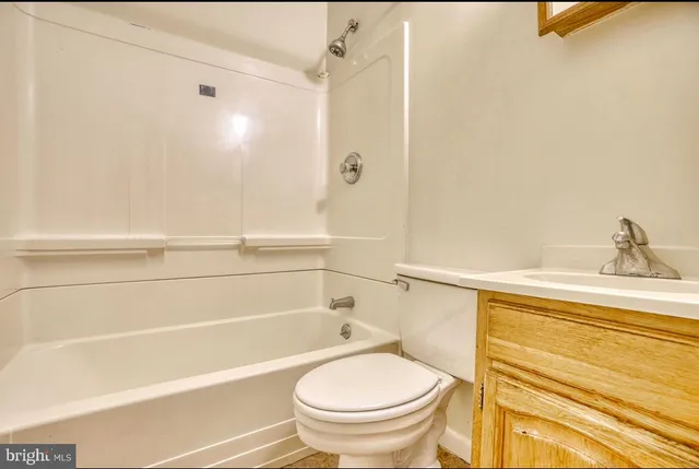 a bathroom with a toilet and a bathtub