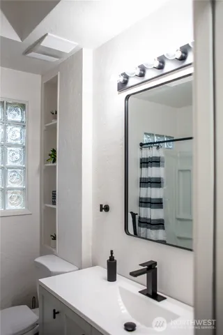 a bathroom with a toilet and a window