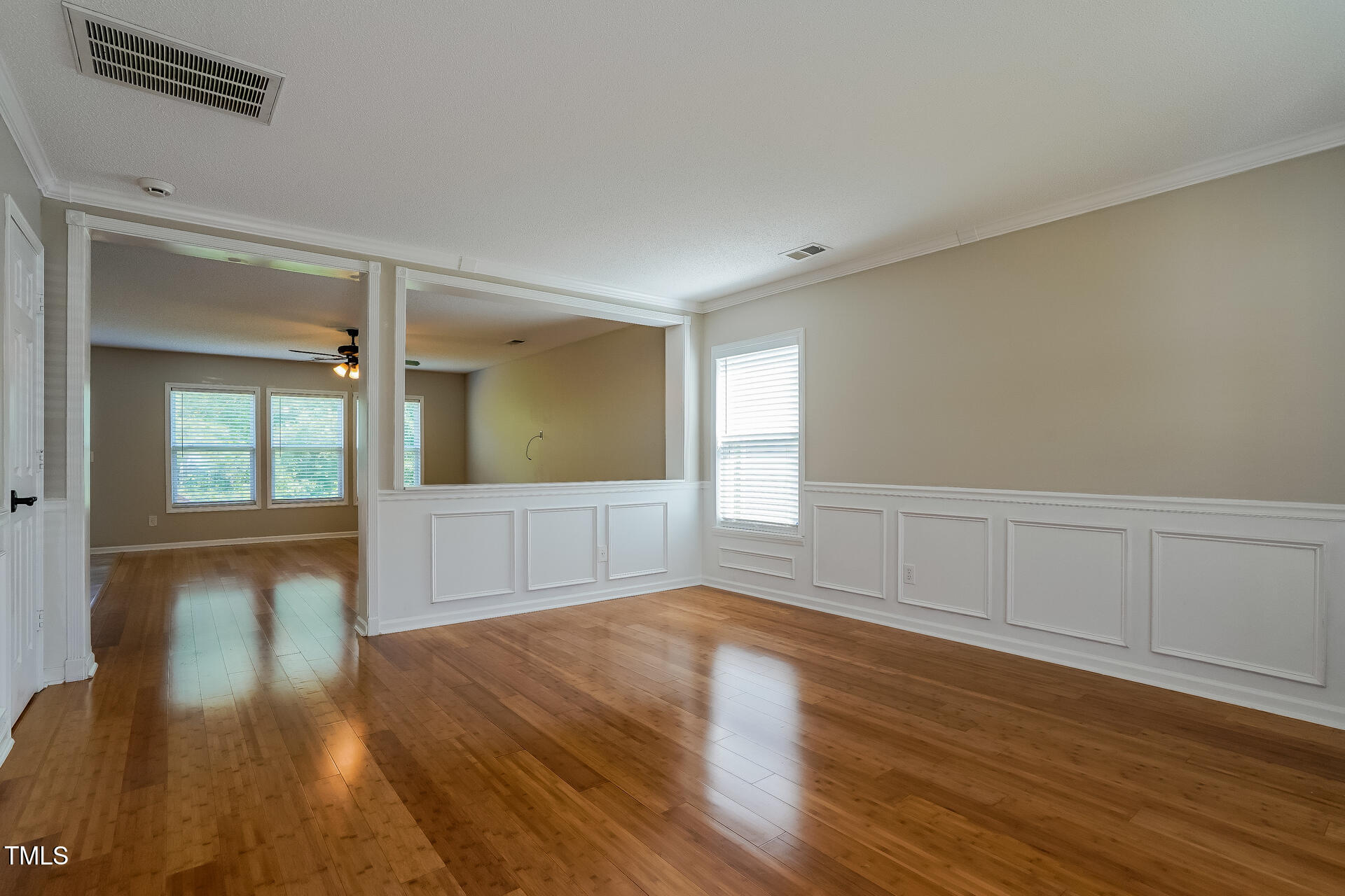 6101 Ricker Road Raleigh, NC 27610 - Photo 9 of 24 a view of empty room with wooden floor and fan
