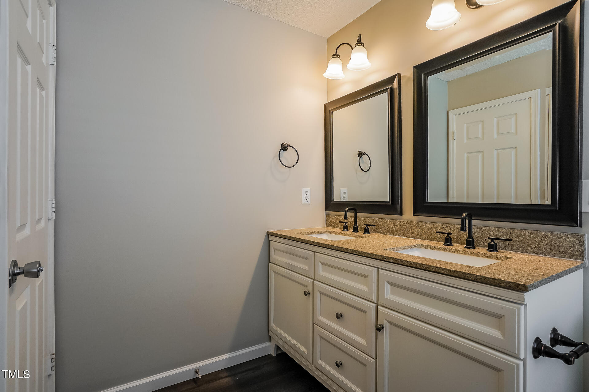 6101 Ricker Road Raleigh, NC 27610 - Photo 13 of 24 a bathroom with a double vanity sink and a mirror